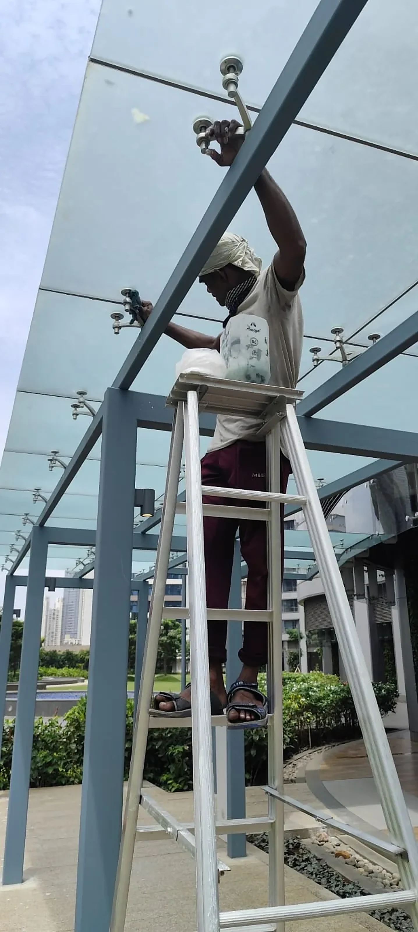 Installer fitting a glass canopy