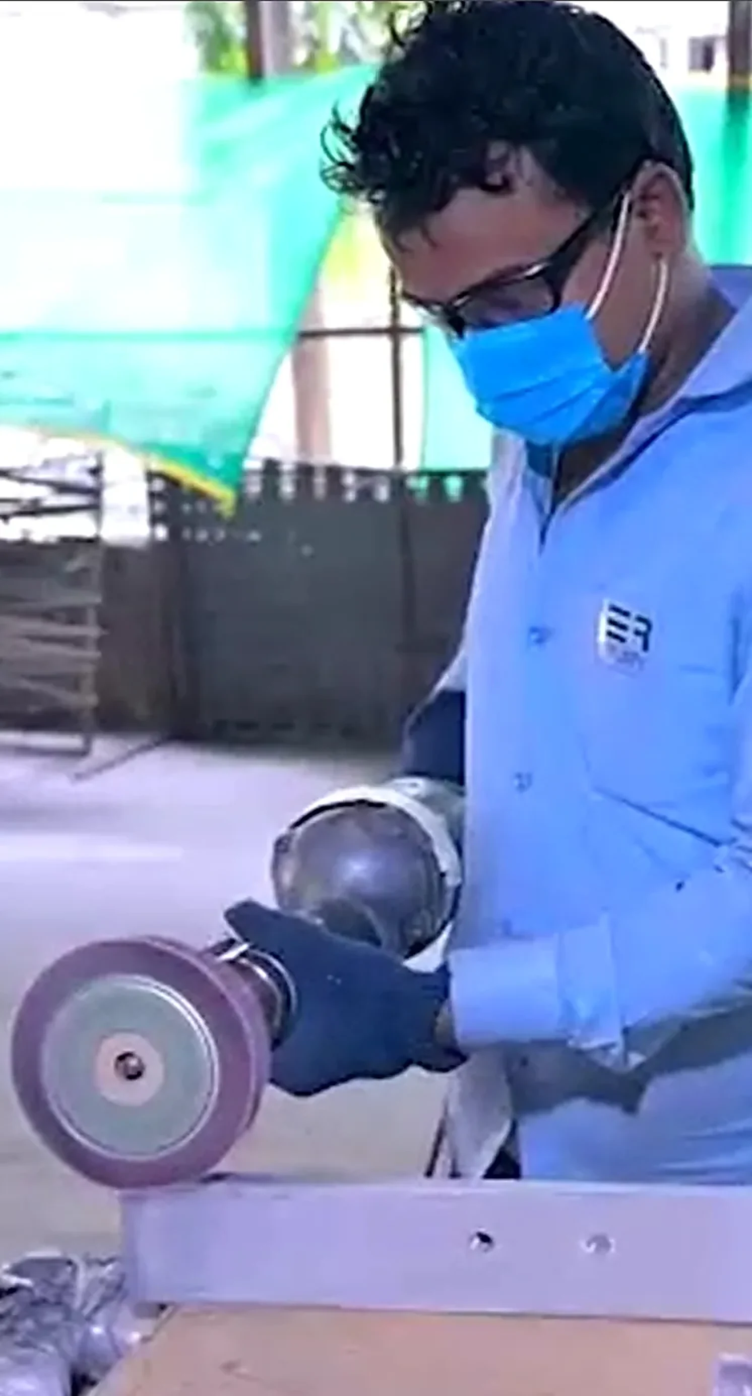 Fabricator grinding a metal component in the Ruby Steels workshop