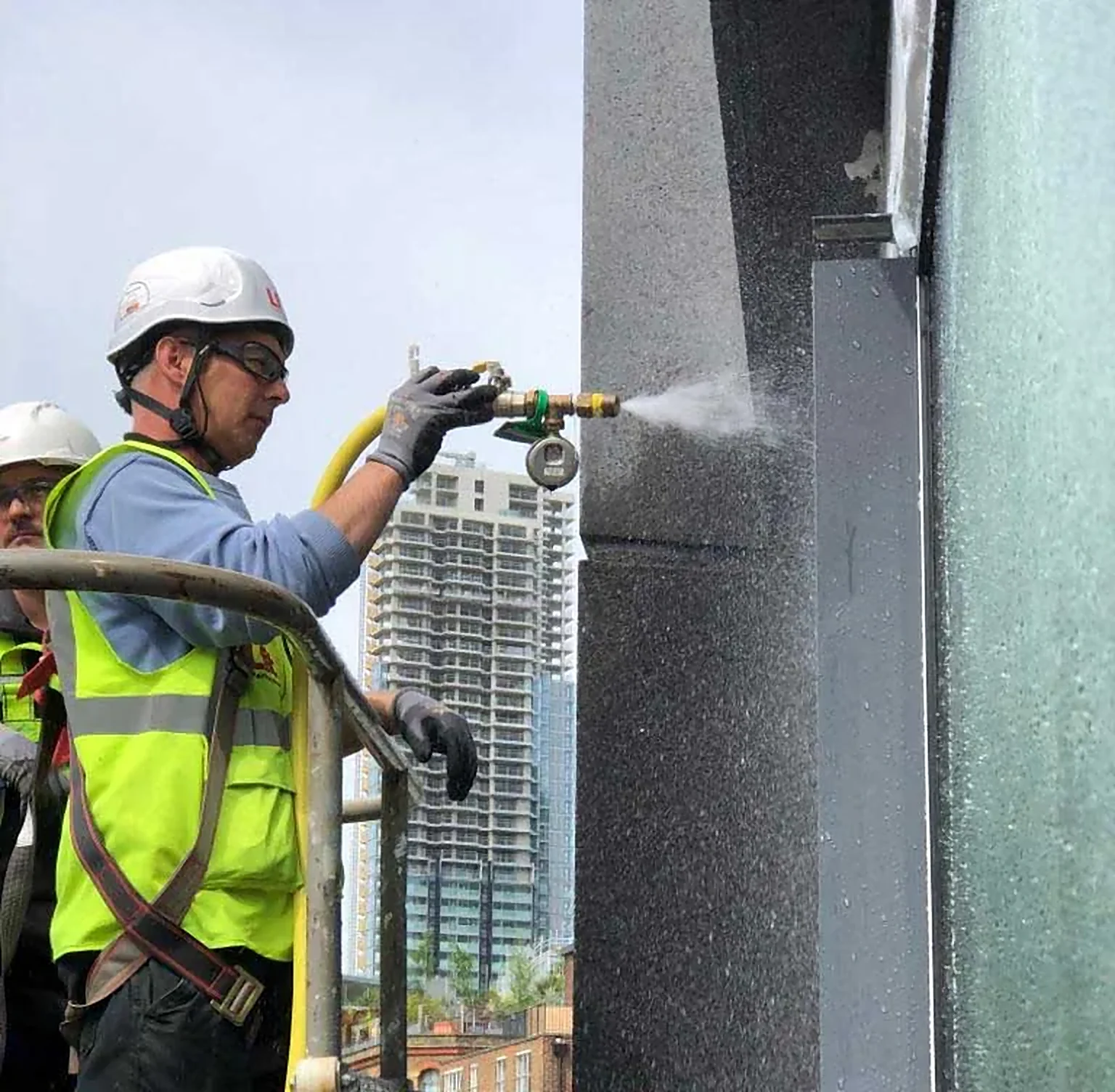 Technician carrying out verification on a high-rise facade